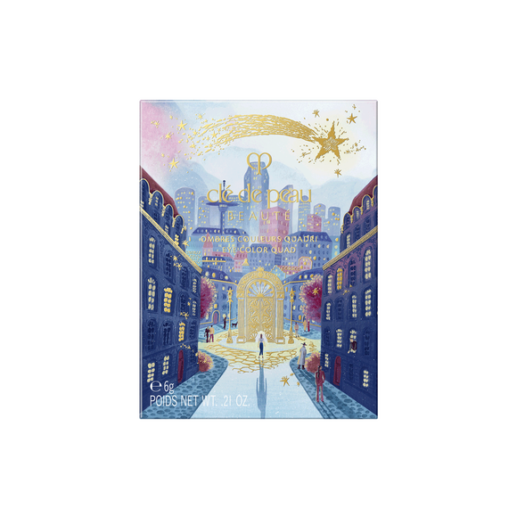 Photo of the 26 AW Holiday Collection limited-edition EYE COLOR QUAD outer box. The rectangular package features a scenic illustration of a city street leading to a large gold gate, detailed with figures under a starry sky with a large gold shooting star across the top.
