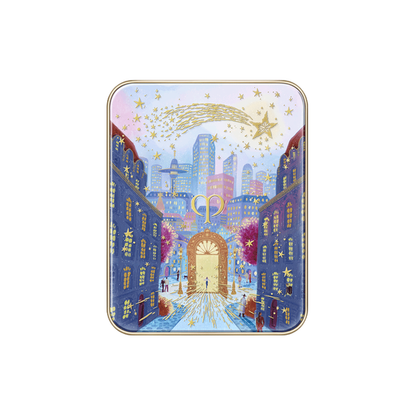 Photo of the 26 AW Holiday Collection limited-edition EYE COLOR QUAD case. The closed rectangular compact lid features a detailed scenic illustration of a city street leading to a large gold gate under a starry sky with a large gold shooting star across the top.